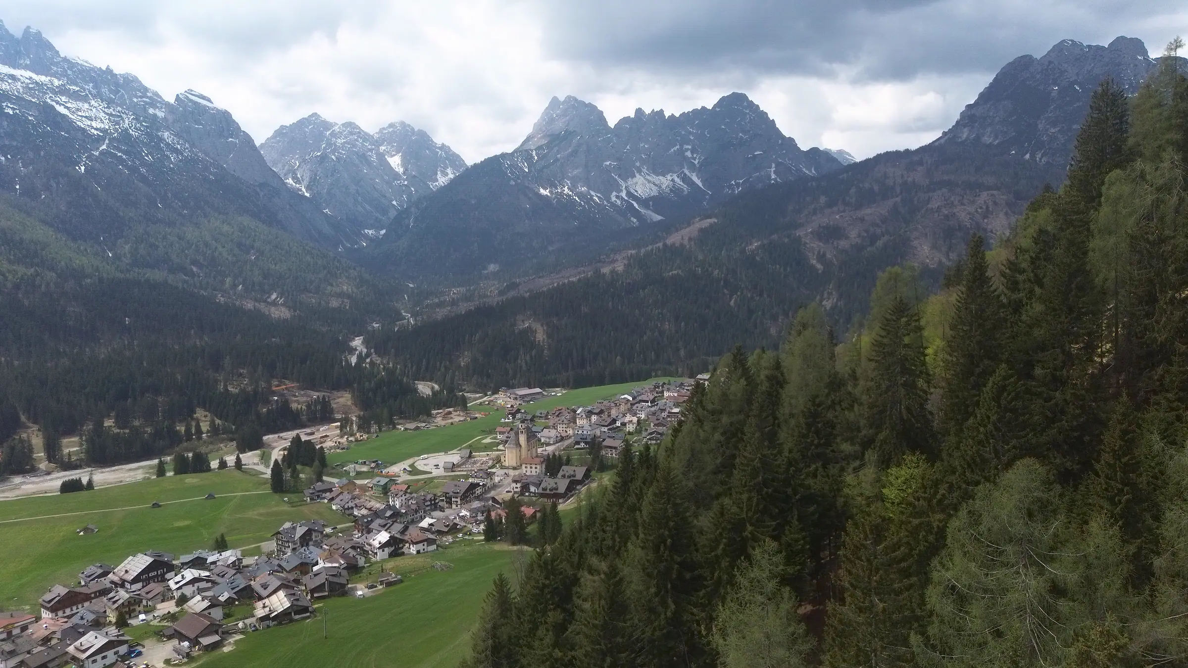 The valley looking west: the houses of Pill in the foreground, Granvilla with the bell tower of the parish church in the middle, and the ridges of the Terze under a cloudy sky.